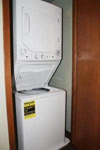 a microwave sitting on top of a washer and dryer at 2 bedroom condo at Wild Eagle Lodge, #133 in Eagle River