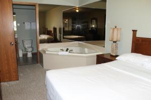 a bedroom with a bed and a bath tub and a bathroom at 2 bedroom condo at Wild Eagle Lodge, #133 in Eagle River