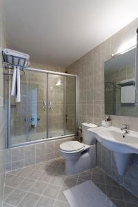 a bathroom with a toilet and a sink and a shower at Kent Hotel in Bursa