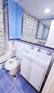 a bathroom with a white sink and a toilet at Blue Oasis in Corralejo +18 photos