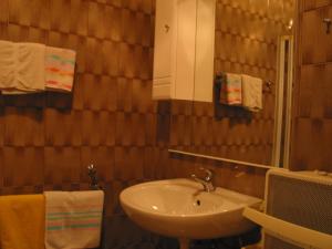 a bathroom with a sink and a mirror and towels at Unser kleines Bauernhaus in Maria Luggau