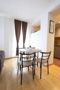 a dining room table and chairs in a living room at Central Prime Apartments 09 in Pristina