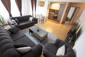 a living room with a couch and a table at Central Prime Apartments 09 in Pristina