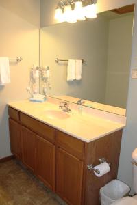 a bathroom with a sink and a large mirror at 2 Bedroom Condo at Wild Eagle Lodge, #232 in Eagle River