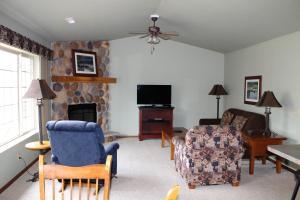 a living room with a fireplace and a tv at 2 Bedroom Condo at Wild Eagle Lodge, #232 in Eagle River