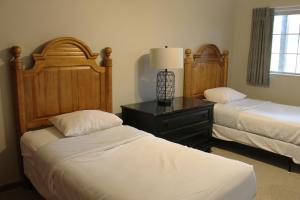 a bedroom with two beds and a table with a lamp at 3 Bedroom condo at Wild Eagle Lodge in Eagle River +33 photos