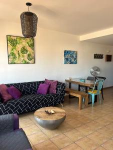 a living room with a couch and a table at Casalegre in El Cotillo