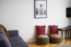 a living room with a couch and two chairs at Cozy apartment with view in Kajaani