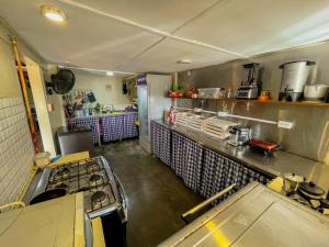 a kitchen with a stove and a counter top at Calipso Bocas Town - Cozy Caribbean House in the Center in Bocas Town