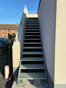 a set of stairs leading up to a building at Chez MJ in Pont-à-Celles
