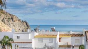 a white building with the ocean in the background at Casa Azure in Luz