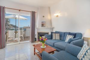 a living room with a couch and a table at Casa Azure in Luz
