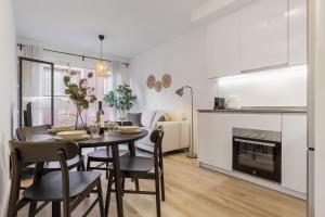 a kitchen and dining room with a table and chairs at ViVi Homes - Anemona , Beach , Balcony, Centre in Fuengirola