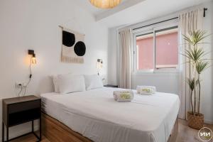 a bedroom with a white bed with two pillows on it at ViVi Homes - Anemona , Beach , Balcony, Centre in Fuengirola