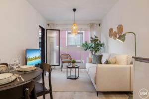 a living room with a couch and a dining room at ViVi Homes - Anemona , Beach , Balcony, Centre in Fuengirola +17 photos