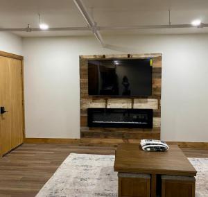 a living room with a flat screen tv on a wall at Luxury 2 Bedroom Lodge Unit 302 in Wilmington