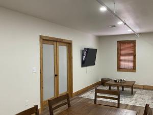 a living room with a table and a tv on the wall at Luxury 2 Bedroom Lodge Unit 302 in Wilmington +2 photos