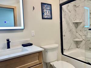 a bathroom with a toilet and a sink and a shower at Luxury 2 Bedroom Lodge Unit 302 in Wilmington