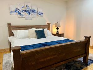 a bedroom with a large bed with blue and white pillows at Luxury 1 Bedroom Lodge Unit 301 in Wilmington