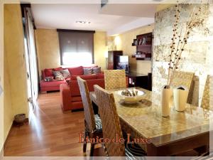 a living room with a table and a couch at ETNICO DE LUXE wifi y aparcamiento gratis in Águilas