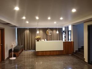 a lobby with a reception desk in a building at Luxe Inn in Kannur