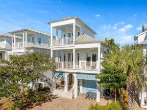 a large white house with a balcony at Sand On Tap in Inlet Beach