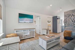 a living room with a couch and a table at Newly Renovated Professional Design Partial Ocean Views in Hampton