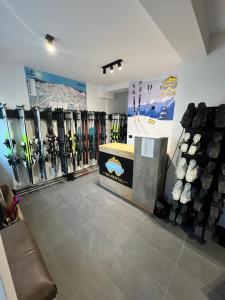 a room with a bunch of skis on the wall at Villa Mont in Jahorina