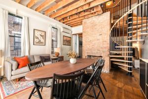 a dining room and living room with a table and chairs at Luxury Loft near Washington Park - Rooftop Deck in Cincinnati +35 photos