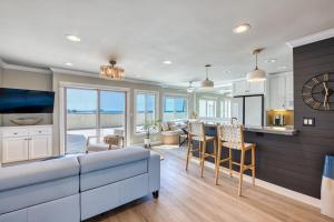 a kitchen and living room with a couch and a table at Ocean and Pier View Condo on the Sand in Huntington Beach
