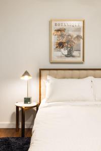 a bedroom with a bed and a picture on the wall at Walk to ALL - Washington Park - FREE Streetcar in Cincinnati