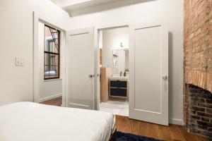 a bedroom with a bed and a brick wall at Walk to ALL - Washington Park - FREE Streetcar in Cincinnati