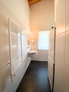 a bathroom with a sink and a toilet in it at Haus Christine in Neukirchen am Großvenediger
