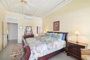 a bedroom with a bed and a chair at Historic Island Hotel in Cedar Key