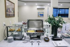 a buffet with pastries on a table in a room at Apart Hotel Acrópolis in Santana do Livramento