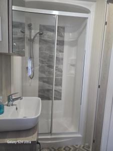 a bathroom with a shower and a sink at Lakeside Holiday Home with Hot Tub in Tattershall