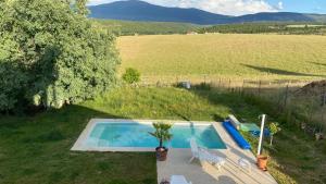 a swimming pool in the middle of a field at Casa Rural Teja Vieja in Duruelo