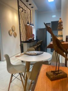a dining room with a table and chairs at Studio Home in Patrocínio +16 photos