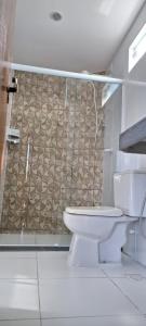 a bathroom with a toilet and a shower at Pousada Recanto do Japa in Nilo Peçanha +111 photos