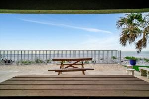a picnic table on the beach near the beach at Stones Throw Beachfront Family Suite #3 VIEWS in Clearwater Beach