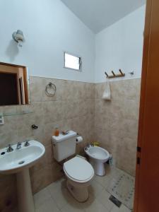 a bathroom with a toilet and a sink at Cabañas Margus in La Granja +26 photos