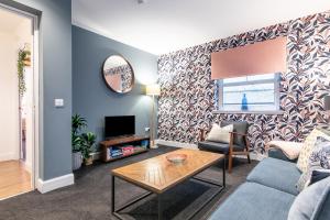 a living room with a couch and a table at Ness Central in Inverness