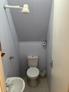 a small bathroom with a toilet and a sink at Chalemar Itanhaém in Itanhaém