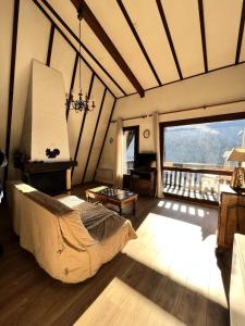 a bedroom with a bed in a room with a window at Résidence Le Peuil - Chalet atypique situé sur les hauteurs du village MAE-3454 in Corrençon-en-Vercors