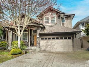 a house with a garage in front of it at Metropolitan Dream Stay with Cozy Fireplace and Hot Tub in Surrey