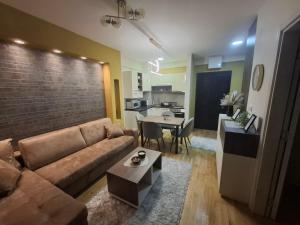 a living room with a brown couch and a table at Astera 2 in Vrnjci