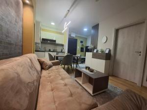 a living room with a couch and a table at Astera 2 in Vrnjci