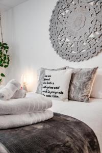 a bedroom with a bed with pillows and a chandelier at The Inspiration Suite at Dream BNB Estate Inn in Leamington
