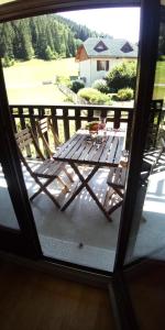 a view from a window of a table on a porch at Résidence Les Quatres Saisons - STUDIO COIN MONTAGNE MAE-4054 in Corrençon-en-Vercors