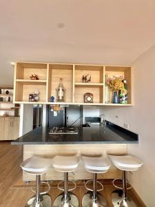 a kitchen with a counter with stools around it at Apartamento con amplia zona de trabajo in Rionegro